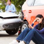 Woman calling her insurance company after an accident